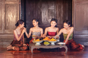 beautiful-thai-girls-in-thai-traditional-costume-and-enjoy-eating-thai-dessert_35977-356